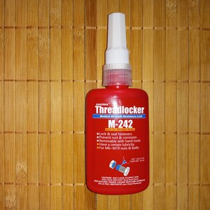 May include: A red bottle of Eskorke Threadlocker M-242 medium strength resistance lock. The bottle has a white cap and a label with instructions for use. The label says "Lock & seal fasteners", "Prevent rust & corrosion", "Removable with hand tools", "Have a certain lubricity", and "For M6-M19 nuts & bolts".
