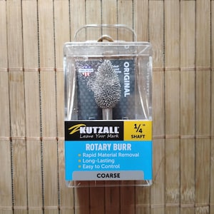 May include: A Kutzall rotary burr with a 1/4 inch shaft. The burr is coarse and is labeled "Original".