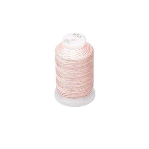 May include: A spool of pale pink thread on a white bobbin.
