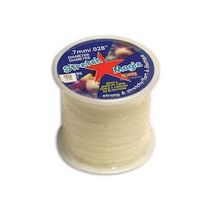 May include: A spool of clear elastic stretch magic bead and jewelry cord, 0.7mm in diameter, strong and stretchy, for beading and jewelry making. The spool is labeled "Stretch Magic" and "Bead & Jewelry Cord".