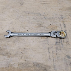 May include: A silver chrome vanadium 10 mm wrench with a flexible head and a gold-colored bearing. The wrench is designed for mechanical work and features a combination open-end and box-end design.