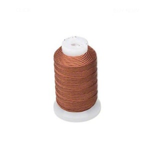 May include: A spool of brown waxed thread for sewing leather or other materials.