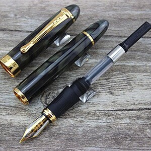 May include: Two black and green fountain pens with gold accents and a black and silver converter pen.