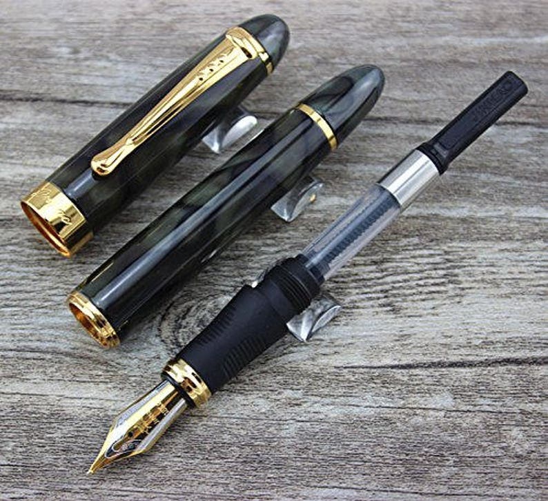 May include: Two black and green fountain pens with gold accents and a black and silver converter pen.