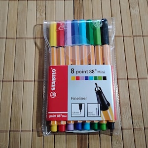 Könnte beinhalten: Eine Packung mit acht Stabilo point 88 Mini Fineliner-Stiften in verschiedenen Farben. Die Stifte befinden sich in einer durchsichtigen Plastikverpackung mit einem roten und weißen Etikett, auf dem "Stabilo point 88 Mini Fineliner" steht.