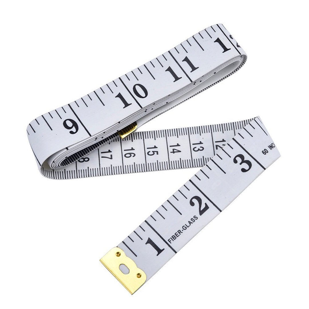 Two rolled-up white and yellow tailor measuring tape on an old