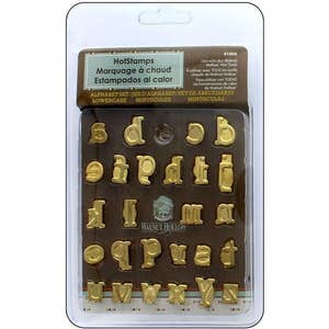 May include: A set of 26 gold-coloured lowercase alphabet letter stamps in a clear plastic package. The package has a brown label with the text "HotStamps" and "Alphabet Set/Jeu d'Alphabet/Bet de Abecedario Lowercase/Minuscule/Minisculas".