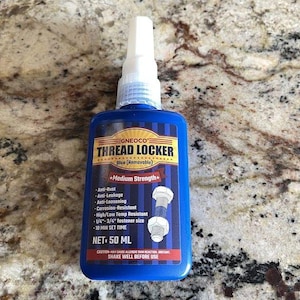 May include: A blue bottle of GNEOCO Thread Locker with a white nozzle. The label features the text "THREAD LOCKER" and "Blue (Removable)". It is a medium strength thread locker, with a net volume of 50 ml.