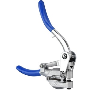 May include: A silver metal hand-held punch tool with blue plastic handles. The tool has a lever and a round punch head.