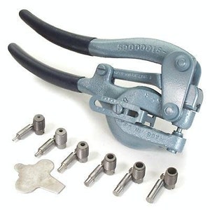 May include: A gray metal punch tool with two handles and a set of eight metal punch tips. The tool is labeled "59000001S".