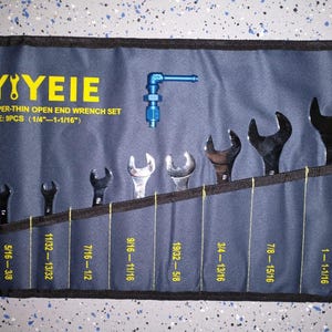 May include: A blue and black wrench set with the text "YIEIE" and "SUPER-THIN OPEN END WRENCH SET" in yellow. The set includes nine open-end wrenches, ranging in size from 1/4" to 1-1/16", displayed in a blue tool roll.