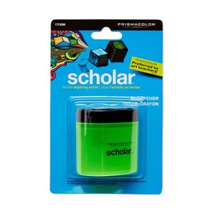 May include: A green and black crayon sharpener with the text "Prismacolor Scholar" on the front. The packaging says "Preferred by art teachers" and "for the aspiring artist | pour l'artiste en herbe".