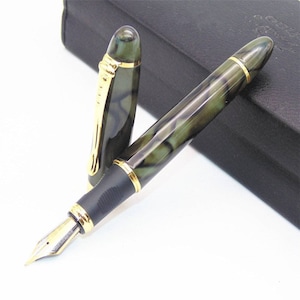 May include: A green and black fountain pen with gold accents. The pen has a marbled design and a black cap.