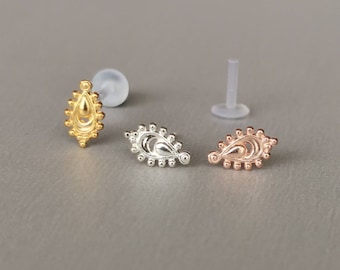 May include: Three gold, silver, and rose gold teardrop-shaped body jewelry pieces with a beaded design. The jewelry is displayed on a white background.