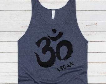 May include: A dark blue tank top with a black Om symbol and the word "VEGAN" printed on it.