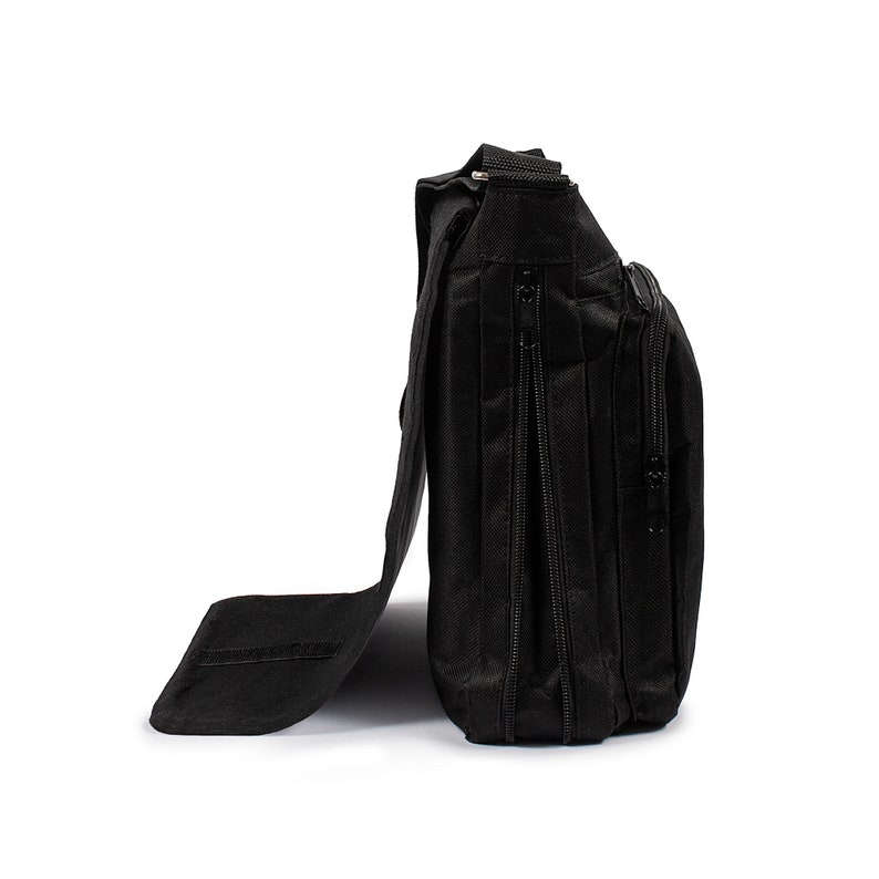 May include: A black messenger bag shown from the side profile, featuring a textured fabric construction, a long flap closure, multiple vertical zippered compartments, and an adjustable shoulder strap attached to the top of the bag structure.