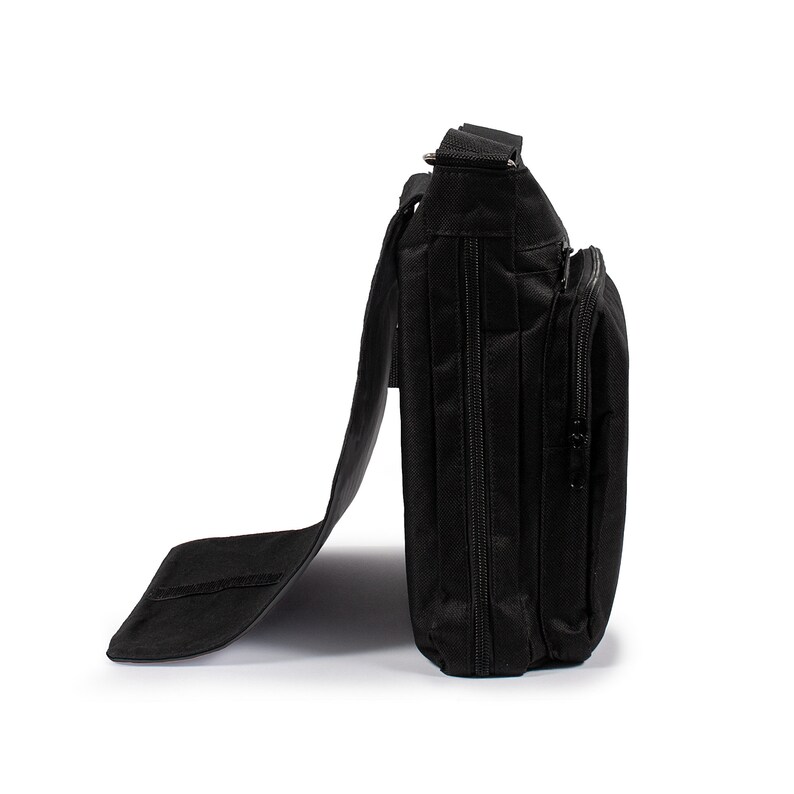 May include: A black messenger bag shown from a side profile view, featuring a structured rectangular body, a long adjustable shoulder strap, and a front flap that is partially open. The bag includes multiple zippered compartments and pockets.