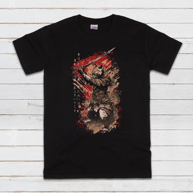May include: Black t-shirt with a graphic of a cat wielding a sword in a warrior pose. The graphic is in shades of brown, red, and white, with Japanese text on the side.