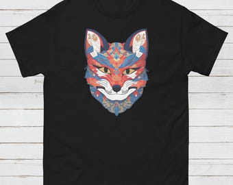 May include: Black t-shirt with a vibrant fox face design. The fox illustration is rendered in red, blue, and gold, with detailed patterns. The t-shirt has a crew neck.