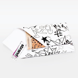 May include: A white envelope with a black and white comic book style design. The envelope is folded and has a small piece of paper sticking out of the top. The paper has Japanese text on it.