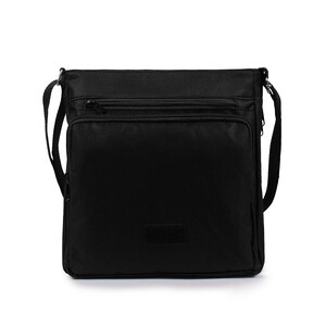May include: A black square-shaped crossbody bag made of durable fabric. It features a main compartment with a zipper closure, a front zippered pocket, and an adjustable shoulder strap attached to the sides. A small rectangular patch is centered.