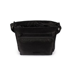 May include: A black crossbody bag featuring a main zippered compartment, a secondary zippered front pocket, and an additional smaller zippered pocket on the front. The bag includes an adjustable shoulder strap attached with silver-toned metal hardware.