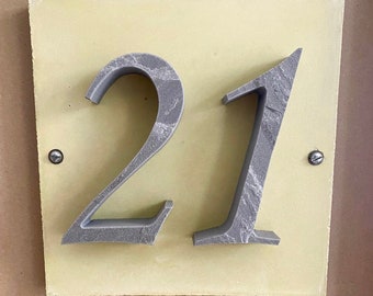 House number "21" of stone