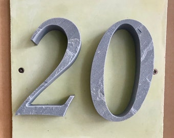 House number "20" of stone