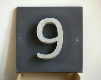 House number "9" of stone