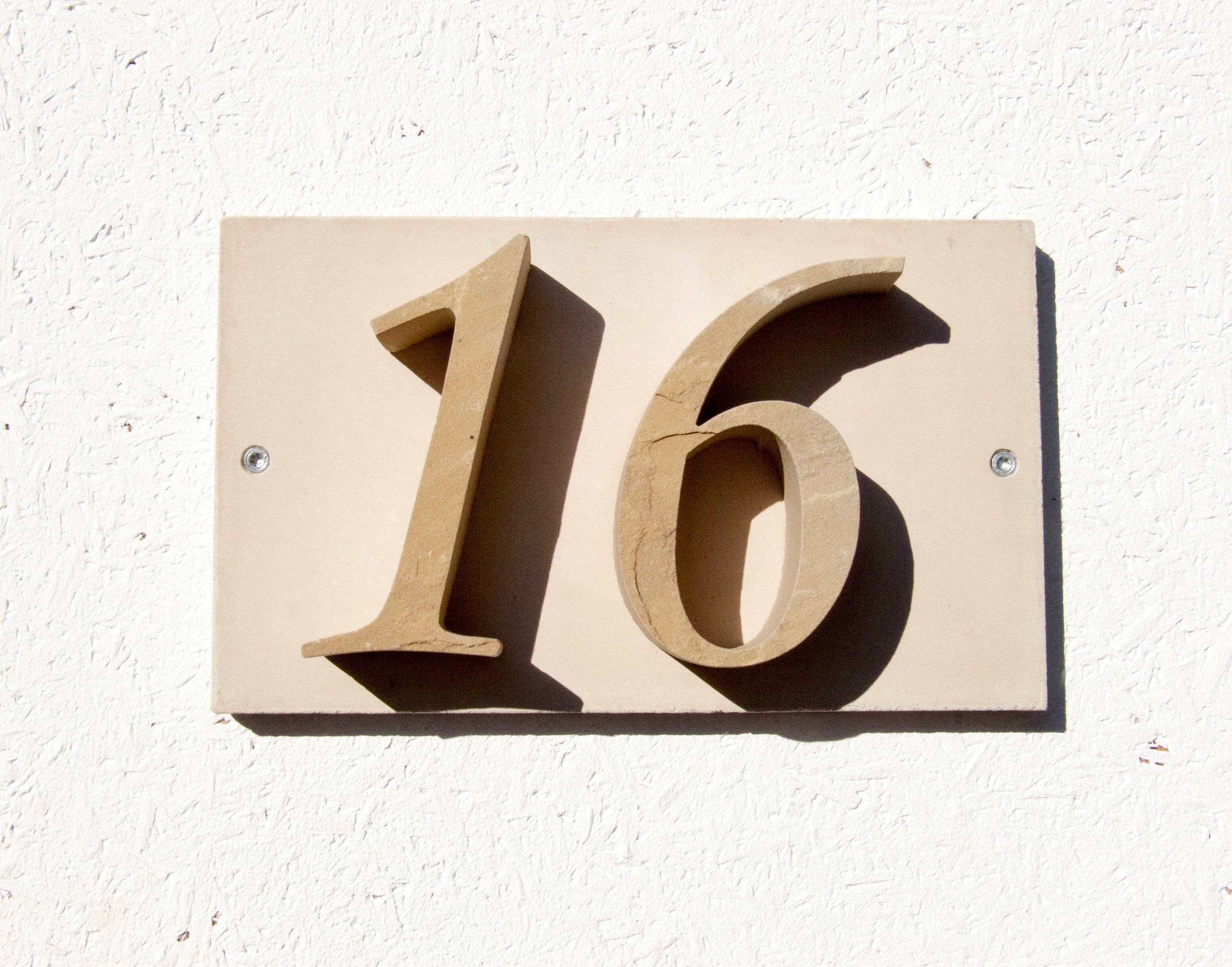 House number "16" of stone