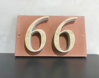 House number "66" of stone