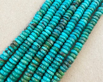 May include: A strand of turquoise beads, each bead is a light blue color with dark green and brown marbling. The beads are round and have a slightly flattened shape.