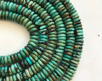 May include: A strand of turquoise beads, each bead is a light to dark green color with brown and black marbling. The beads are round and have a slightly flattened shape.
