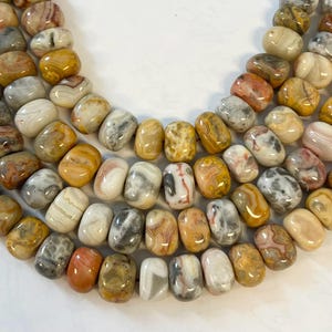 Naturalne koraliki z agatu Crazy Lace o wymiarach 16 x 12 mm, z bryłkami o długości 15,5 cala