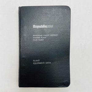 May include: A black, leather-bound notebook with the text "Republicsteel" in white lettering. The notebook also has the text "Mahoning Valley District Warren Plant Niles Plant Plant Equipment: Data" in white lettering.