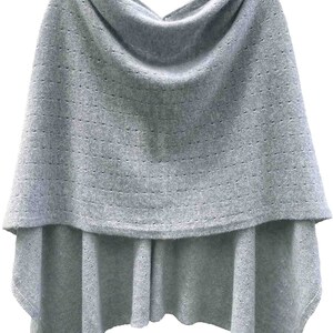 May include: A light gray knitted poncho with a cowl neck and a delicate openwork pattern.