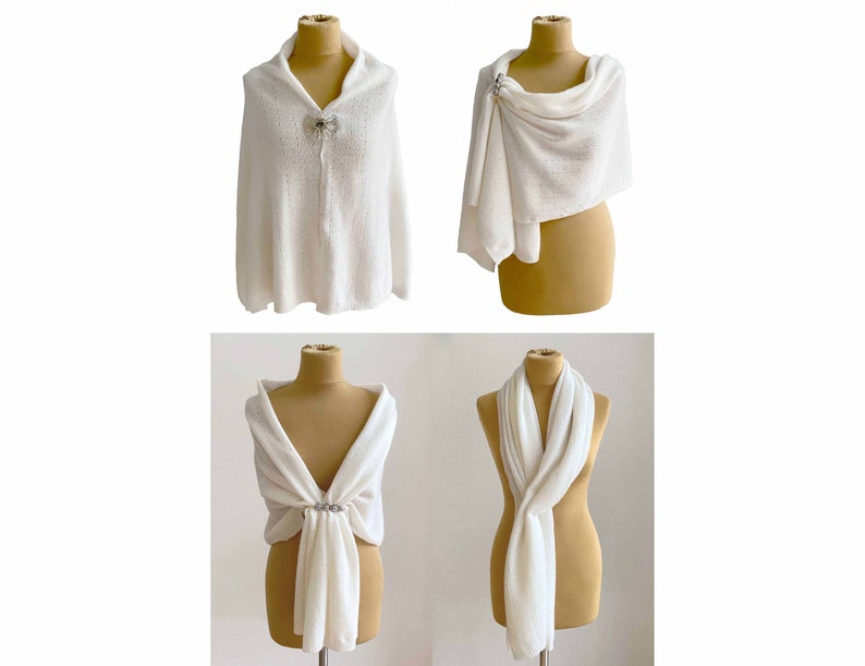 May include: Four white knitted shawls displayed on mannequins. Each shawl is styled differently, showing various ways to wear the garment. The shawls are made of a soft, lightweight fabric and feature a delicate, open-weave pattern.