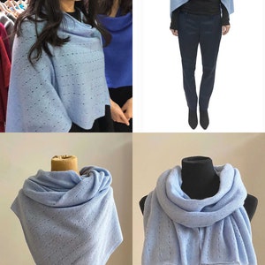 May include: A light blue knitted scarf with a delicate openwork pattern. The scarf can be worn as a shawl or wrapped around the neck.