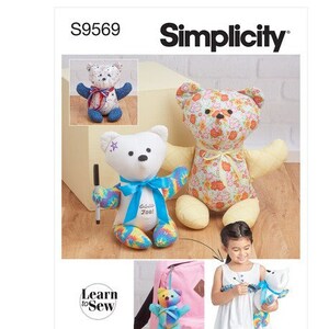 May include: Simplicity sewing pattern S9569 featuring teddy bears. One bear is white with a blue bow and a pen, another is floral. The pattern includes a small bear keychain and a child holding a bear. The words "Learn to Sew" are also visible.