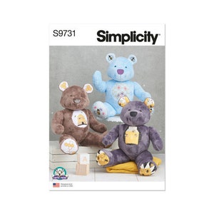 May include: Simplicity sewing pattern S9731 featuring three plush teddy bears in brown, blue, and purple. The bears have decorative accents and are sitting on a white surface. The pattern includes the text "Simplicity".
