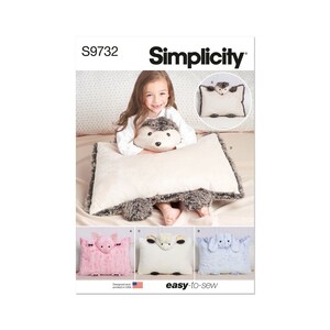 May include: Simplicity pattern S9732 features animal-shaped pillows. The main pillow is rectangular with a hedgehog design, cream-colored with gray accents. Below are three smaller pillows: a pink pig, a white sheep, and a blue bunny. The text "easy-to-sew" is visible.