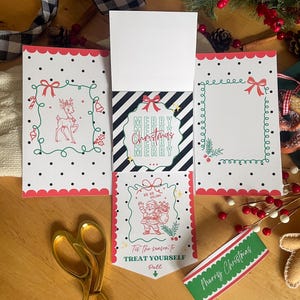 May include: Christmas-themed greeting cards with red scalloped edges, featuring festive illustrations and the text "Merry Christmas." The cards are decorated with reindeer, Santa Claus, and decorative frames. A green and red "Merry Christmas" tag is also visible.