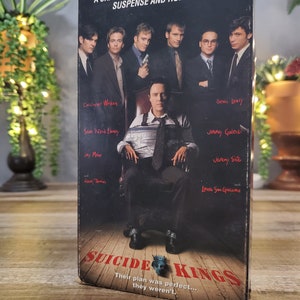 May include: A VHS tape for the movie "Suicide Kings" with a group of men in suits. The cover features the film's title in red, and the tagline "Their plan was perfect... they weren't."