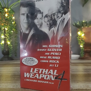 May include: Sealed VHS tape of the movie "Lethal Weapon 4". The cover features Mel Gibson, Danny Glover, Joe Pesci, Rene Russo, Chris Rock, and Jet Li. The title is in large red letters, with the tagline "The Gang's All Here."