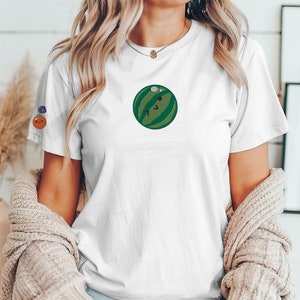 May include: White t-shirt with a green watermelon graphic on the front.