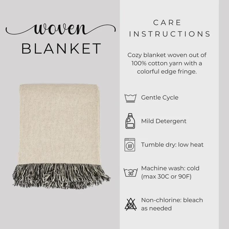 May include: A woven blanket with a neutral color scheme, featuring a cream-colored body and a black and white fringe. The text "woven BLANKET" is at the top left. Care instructions are also included.