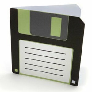 May include: A folded greeting card shaped like a 3.5-inch floppy disk. The card features a black and light green colour scheme with a central white label area containing five horizontal black lines for writing, mimicking a classic data storage disk.