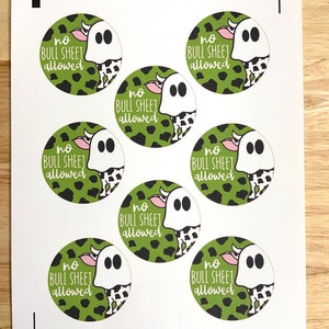 May include: Seven green and black cow print stickers with a ghost wearing a cow print costume. Each sticker says "no bull sheet allowed".