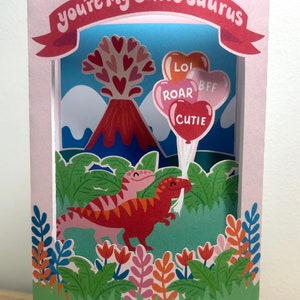 Carte de Saint-Valentin dinosaure rapaces pop-up 3D, fleurs, amour, cœurs, enfants, ballons
