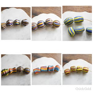 May include: A collection of multi-colored glass beads featuring various shapes and striped patterns. The beads display horizontal and wavy lines in shades of blue, yellow, red, orange, and black, arranged on thin wires across six separate panels.